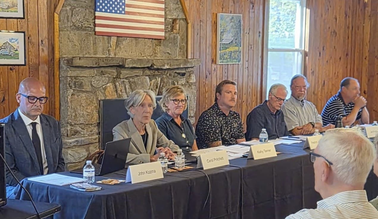 Candidates seated at a table with name placards at the Oct. 1 Lake Lure candidate forum, including John Kozma, Carol Pritchett, Kathy Tanner and Friedrich Jaeger-Faber