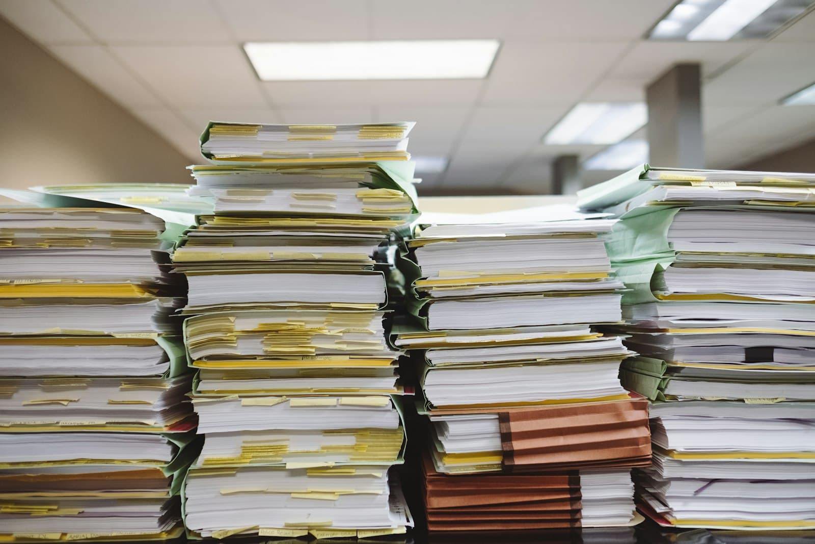 Stacks of paper documents and file folders, representing the settlement agreement the Town of Lake Lure released in the Second Mountain lease dispute